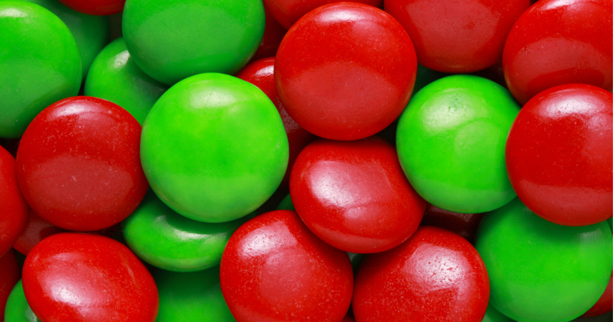 A vibrant photo of red and green Smarties representing the emotional shift from inner conflict (Red) to clarity and connection (Green) in War to Peace®.