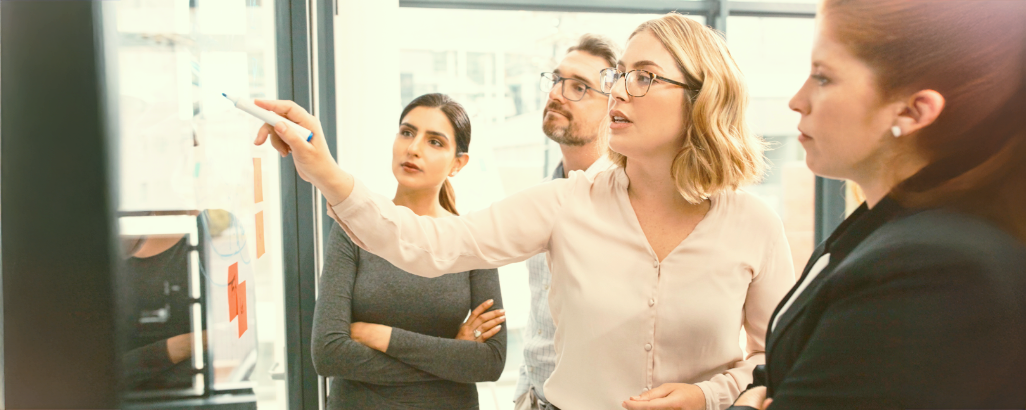 Business professionals in a negotiation training session, learning War to Peace® and Harvard’s Seven Elements framework for conflict resolution.